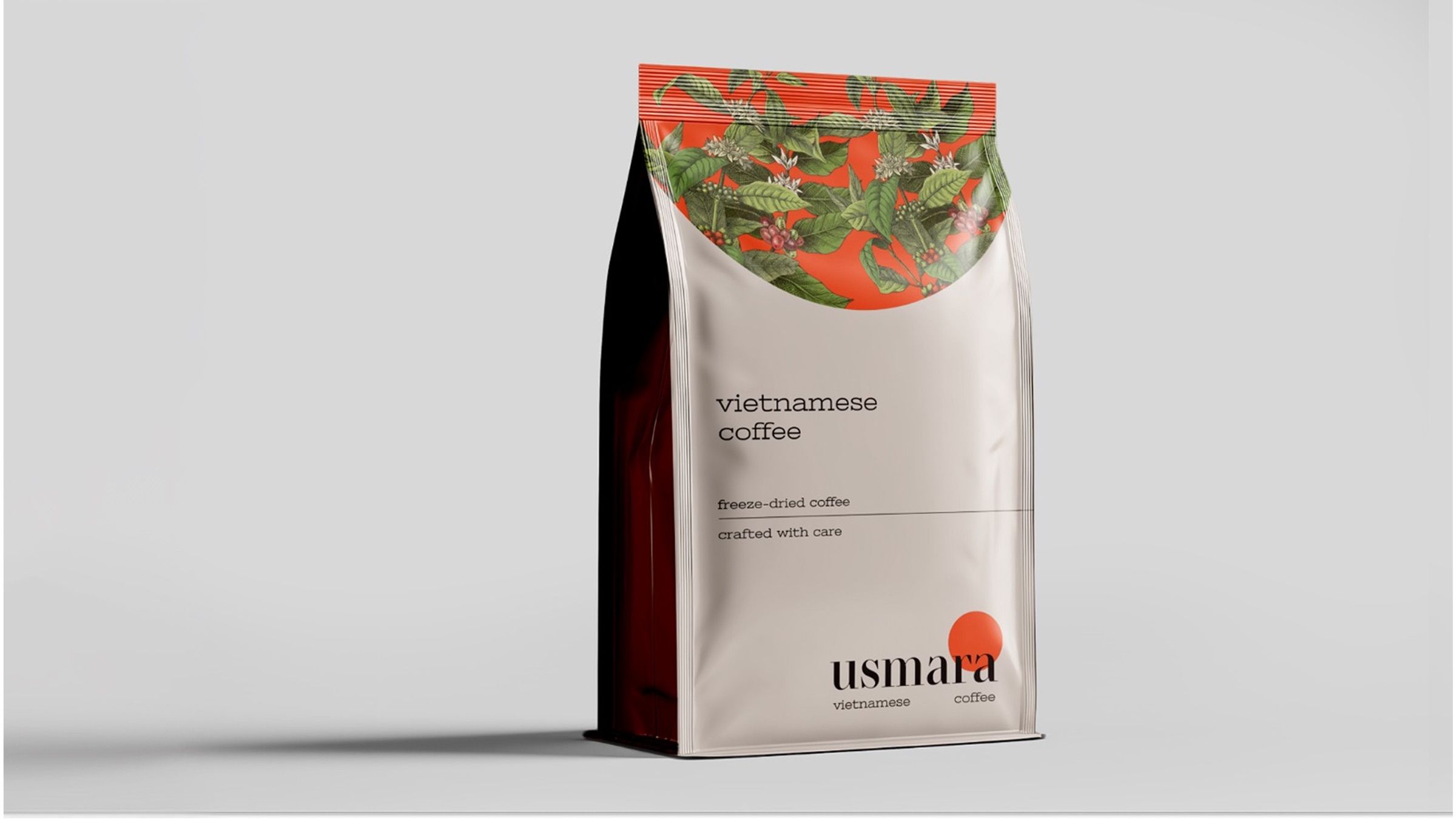 Usmara coffee pouch with a band of illustrated coffee branches and a red sun above the wordmark.